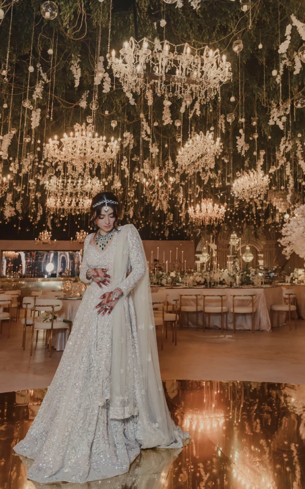 Novia en salón de bodas con muchos candelabros